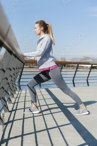 Young woman stretching after running