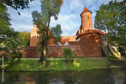 Gothic castle of the Prince-Bishopric of Warmia by the Lyna River in Olsztyn, Poland photo