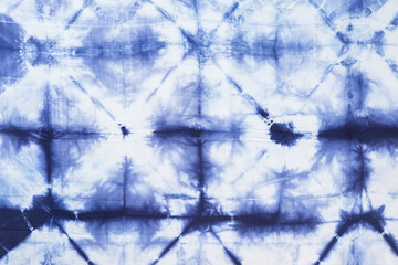 Pattern of blue tie batik dye on cotton cloth, Dyed indigo fabric background and textured, Painted blue watercolor on white cotton cloth