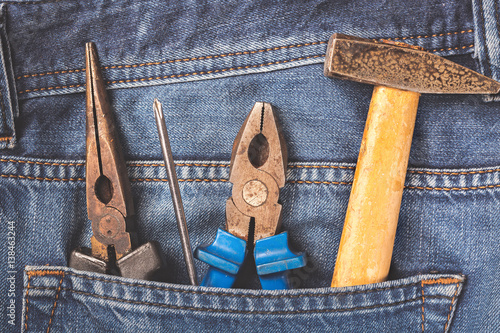 Working tools in jeans pocket. Close up photo