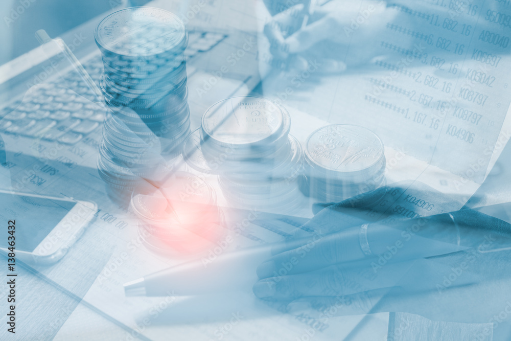 Business woman hand check economy graph with on project at office desk in office and Set coin on book bank, Concept business and finance. The Picture Style Double exposure. Business woman hand check economy graph with on project at office desk in office and Set coin on book bank, Concept business and finance. The Picture Style Double exposure.