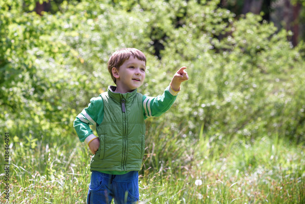 Five year old boy looking and pointing his finger at the strange Five year old boy looking and pointing his finger at the strange