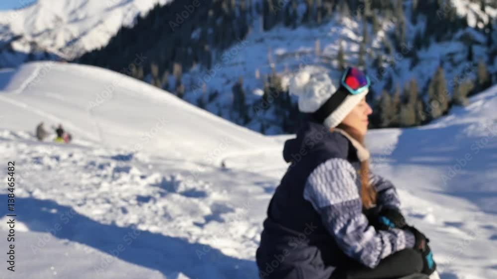 Portrait of beautiful young snowboarder woman looking at aerial view. Portrait of beautiful young snowboarder woman looking at aerial view.