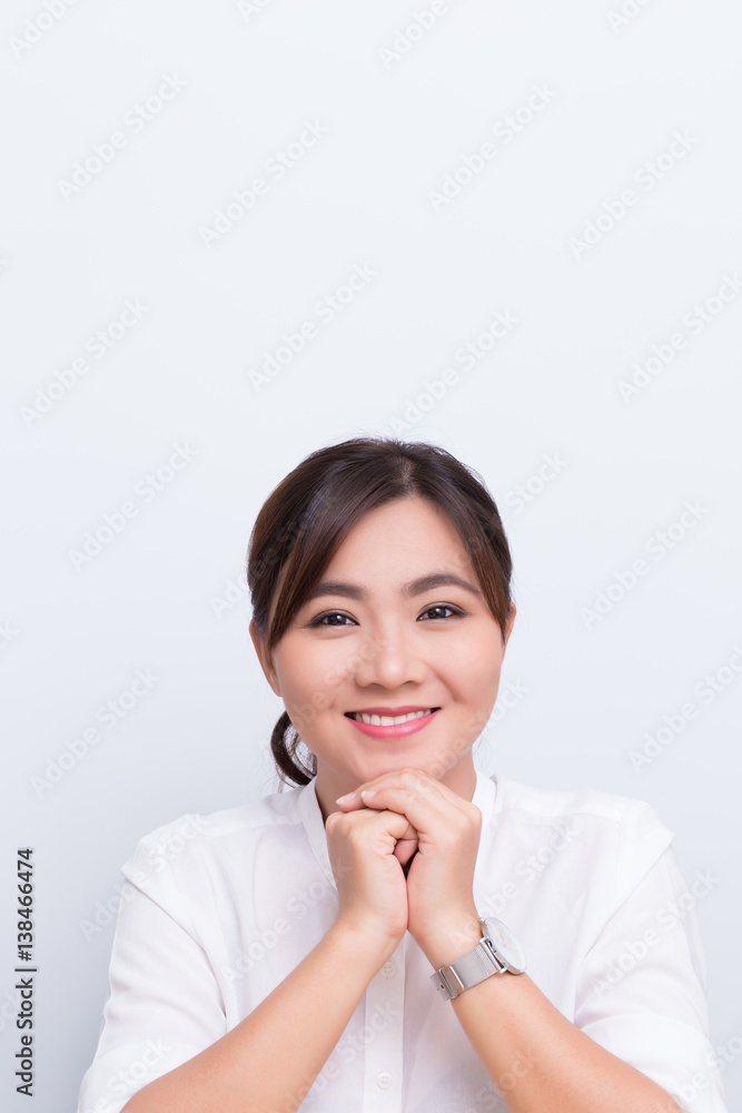 Asian woman pointing to the copy space isolated on blue background Asian woman pointing to the copy space isolated on blue background