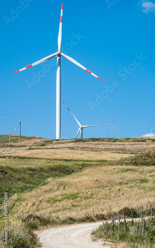 Wind turbines against the blue sky in the Sicily countryside photo