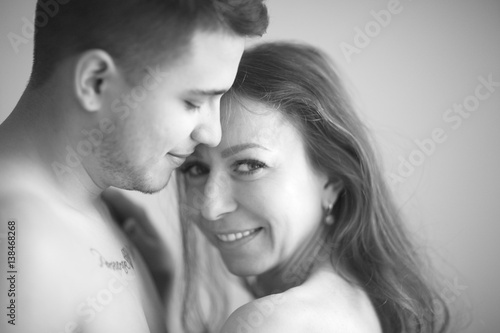 Happy woman in embraces a young man.