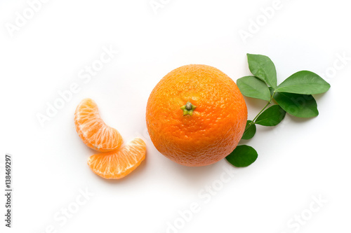 Ripe orange mandarin with green leaves and slices. Isolated fruit concept