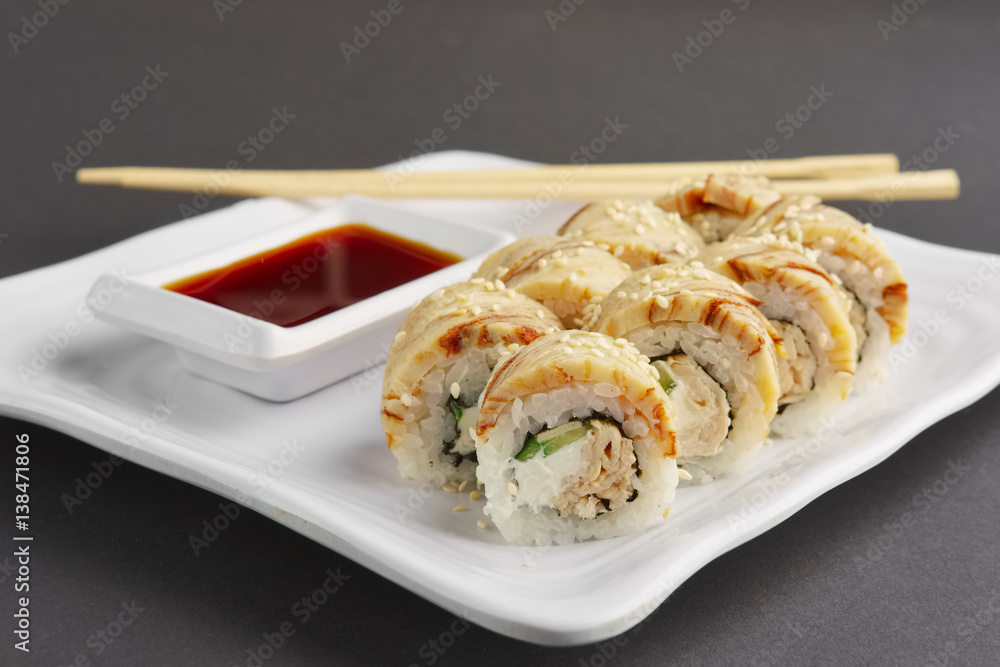 Closeup view of chicken teriyaki roll with chopsticks and soy sauce Closeup view of chicken teriyaki roll with chopsticks and soy sauce
