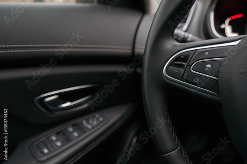 Mobile phone control unit on the steering wheel and door trim. © vpilkauskas
