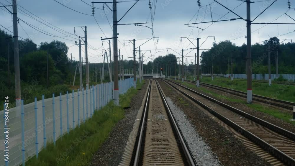 Train passing through countryside, moving railroad tracks in day Train passing through countryside, moving railroad tracks in day