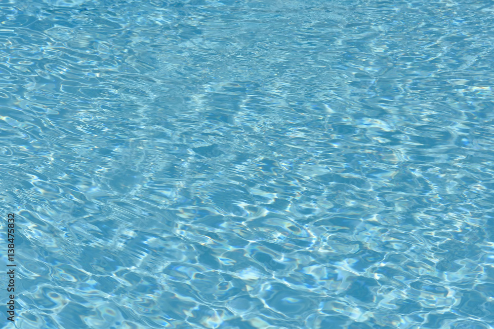 Blue and bright water surface and ripple wave in swimming pool