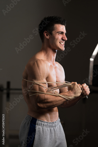 Bodybuilder Wrapt Up With Cable photo