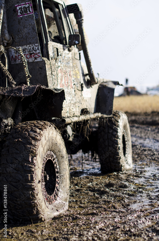 Off-road car in a puddle making mud splashes. Off-road car in a puddle making mud splashes.