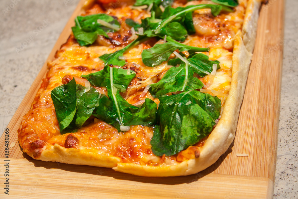 Pizza with basil and cheese on a wooden board. Pizza with basil and cheese on a wooden board.