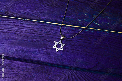 David star jewish symbol on a wooden background with book photo