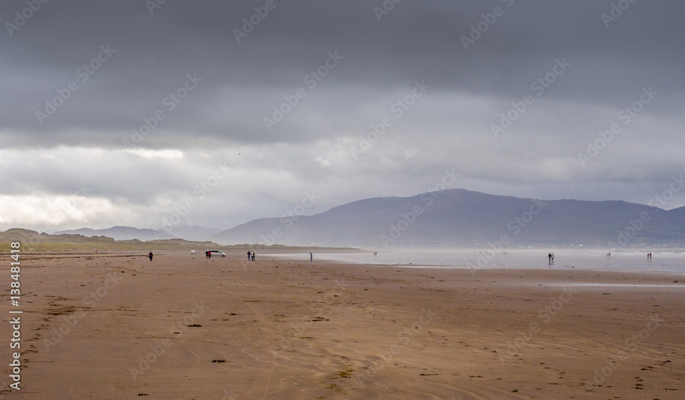 Visitors taking a walk on the beautiful Inch beach, Dingle bay, Republic of Ireland. Visitors taking a walk on the beautiful Inch beach, Dingle bay, Republic of Ireland.