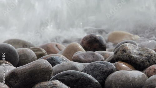 waves crash over a rocky beach closeup