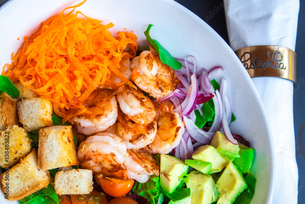 Shrimp salad with cherry tomatoes and natural condiment in a white bowl. Shrimp salad with cherry tomatoes and natural condiment in a white bowl.