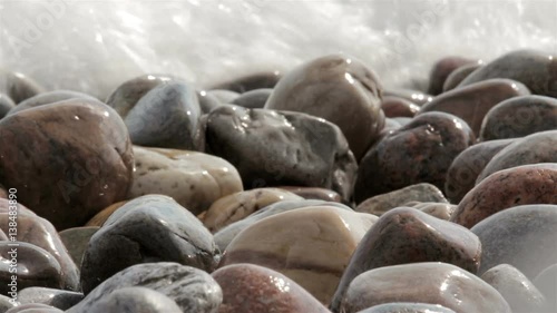 waves crash over a rocky beach closeup