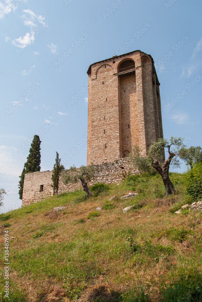 Medieval stone tower on the top of the hill surrounded by olive and cypress trees, Mount Athos, Greece