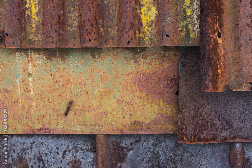 Backdrop of the barn covered with old rusty tin sheets and slate, background