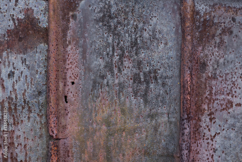 Backdrop of the barn covered with old rusty tin sheets and slate, background