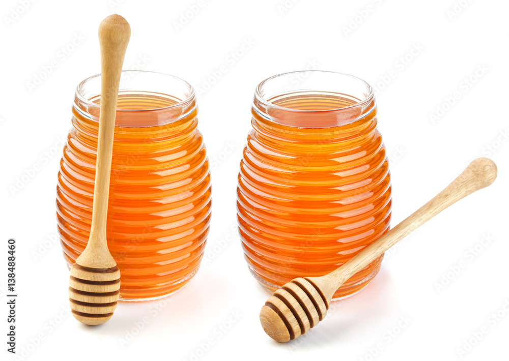 Honey in glass jar isolated on white background Honey in glass jar isolated on white background