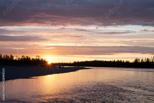 Sunset on the taiga river. River Omulevka. Yakutia. Russia. © olenyok