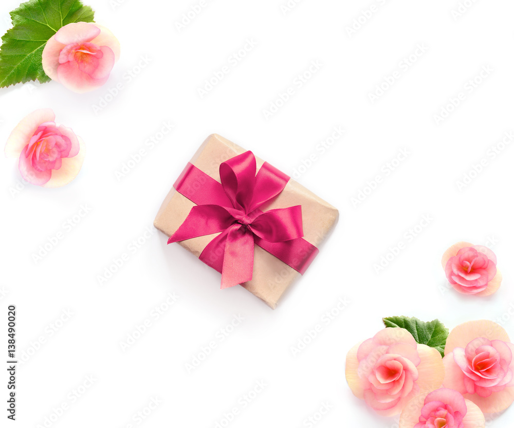 gift box with red ribbon and bow on white with flowers background. flat lat, top view gift box with red ribbon and bow on white with flowers background. flat lat, top view