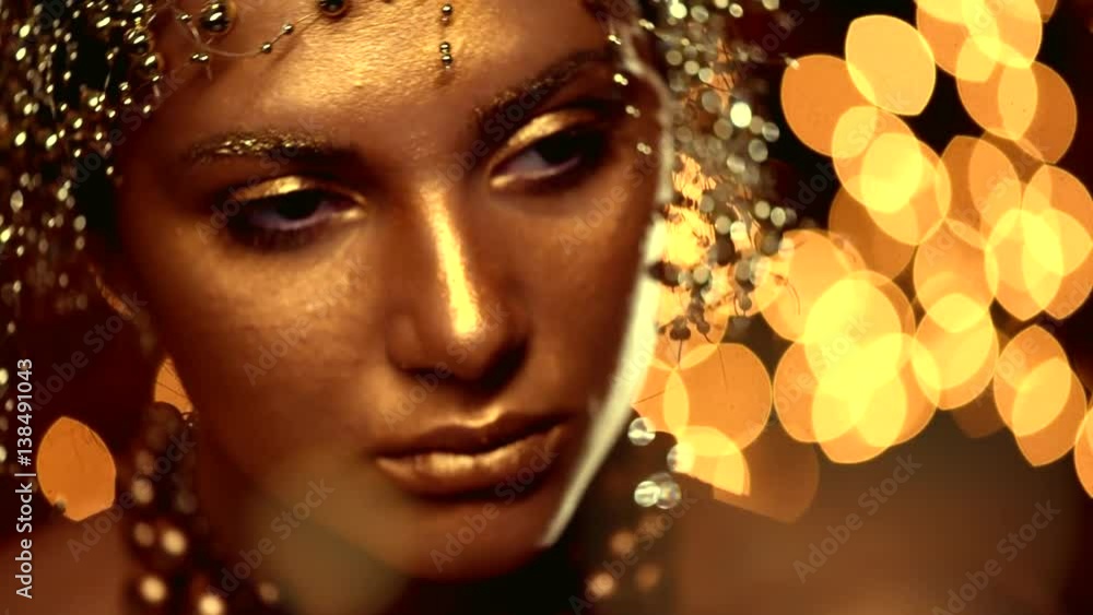 Fashion art golden skin woman face portrait closeup. Glamour shiny professional makeup. 4K Slow motion UHD video Fashion art golden skin woman face portrait closeup. Glamour shiny professional makeup. 4K Slow motion UHD video