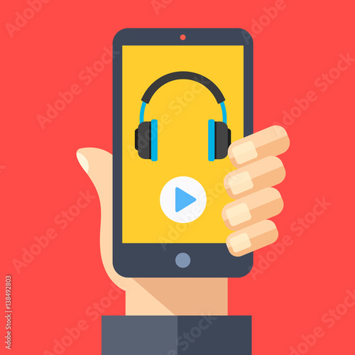 Headphones and play button on smartphone screen. Hand holding smartphone. Streaming service, music app, listening to music on mobile device. Modern flat design graphic elements. Vector illustration