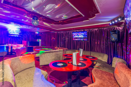 Karaoke room interior with colorful spot lights.