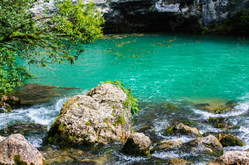 Mountain pond with beautiful green-blue water.