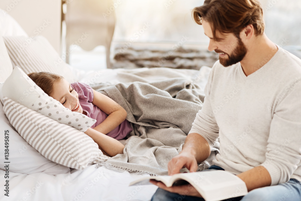 Young father holding book in his hands Young father holding book in his hands