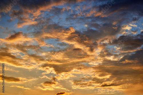Sunset sky, beautiful clouds, bright orange and dark blue colors. © soleg