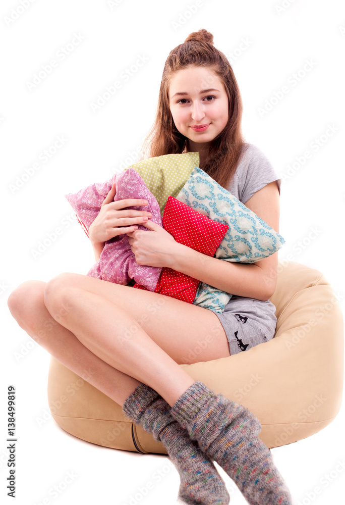 Fototapeta premium Attractive girl play pillow fight isolated