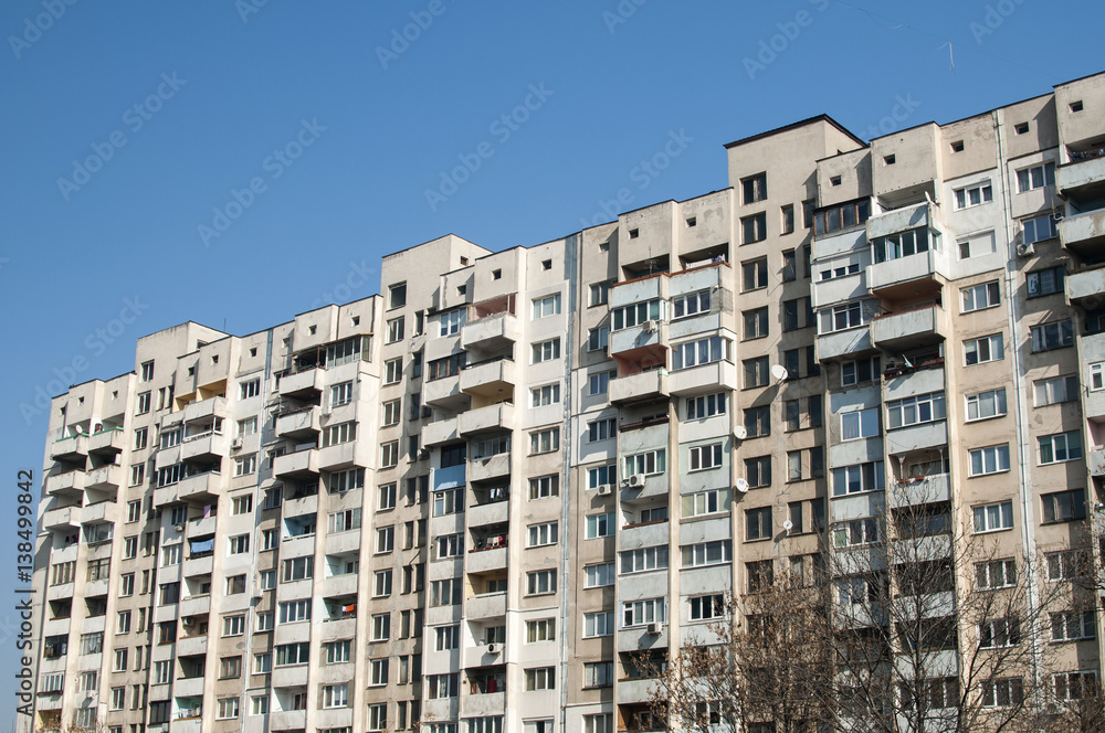 Large obsolete suburban apartment building in clear sunny day