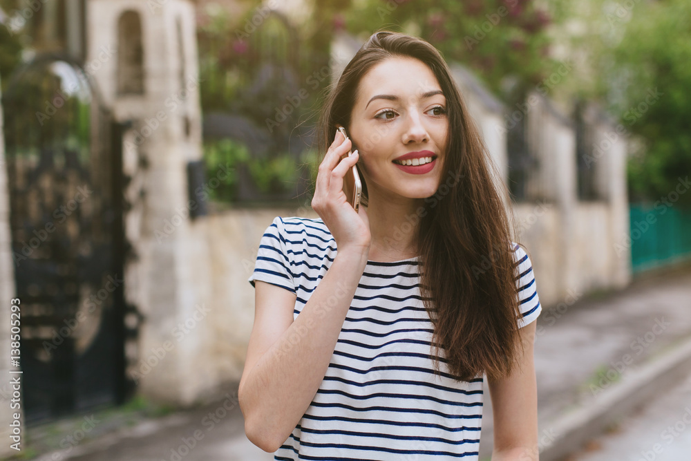 Beautiful stylish and fashionable girl calling in the street. Beautiful stylish and fashionable girl calling in the street.