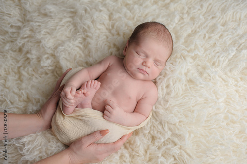 Sleeping Newborn Baby Boy with Mother's Hands
