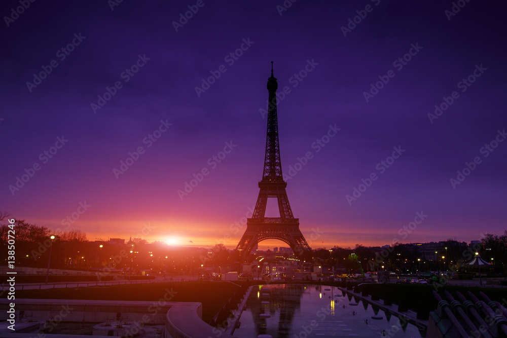 Awesome incredible pink-orange-lilac sunrise. View of the Eiffel Tower from the Trocadero. Beautiful cityscape in backlit morning sunbeam. Paris. France.