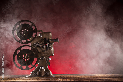 Old style movie projector with smoke on background  close-up.