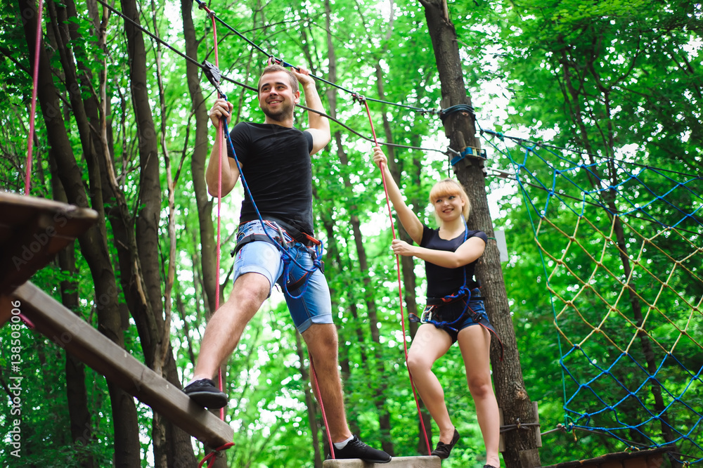 Fototapeta premium Hiking in the rope park two young people