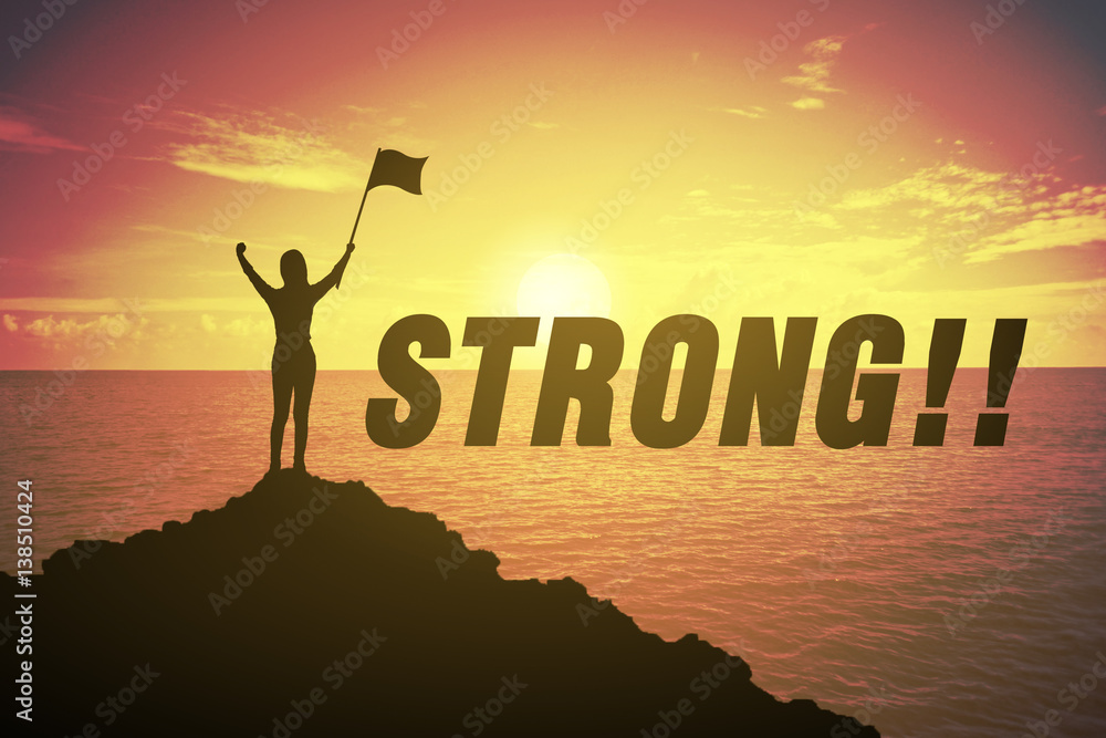 Silhouette young woman standing and raising up her hand and flag about winner concept and STRONG text over a beautiful sunset or sunrise at the sea. background for happy. success in 2017 Silhouette young woman standing and raising up her hand and flag about winner concept and STRONG text over a beautiful sunset or sunrise at the sea. background for happy. success in 2017