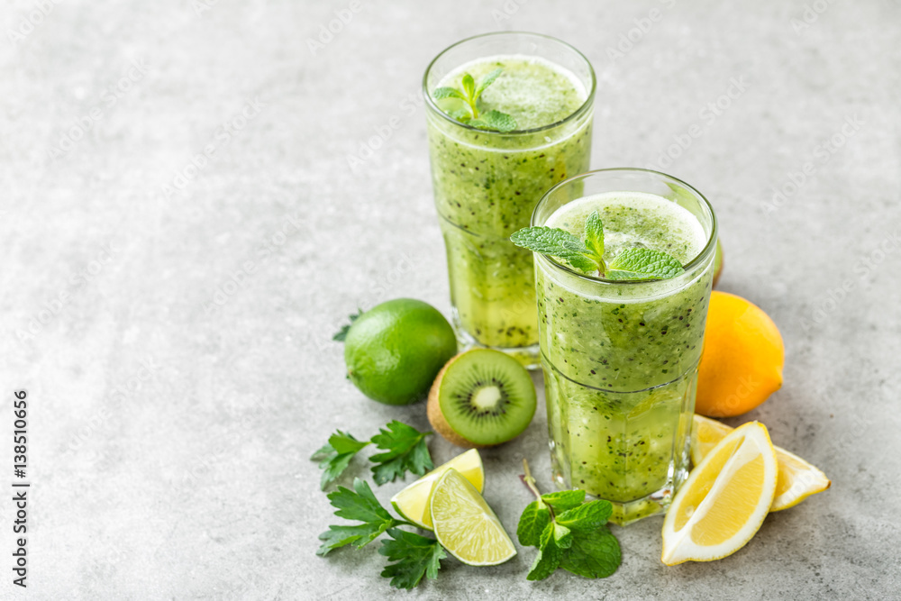 Fototapeta premium fat burning green fruit cocktail with kiwi, lemon, mint and parsley for slimming and healthy diet with space for a text