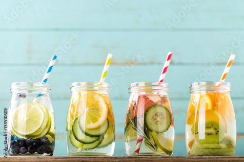 Variety of fruit infused detox water in jars for a healthy diet eating © Sunny Forest