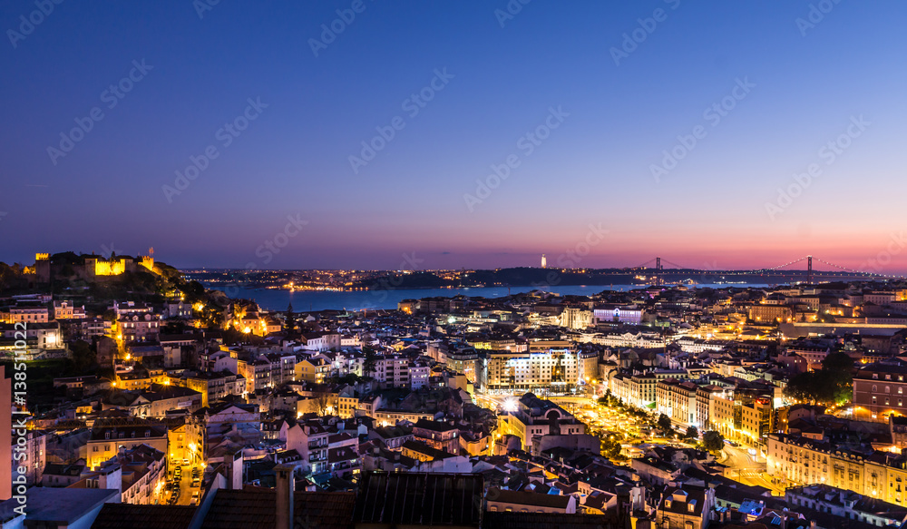 Aerial evening Panorama of Lisbon - illuminated Avenues and river in the background