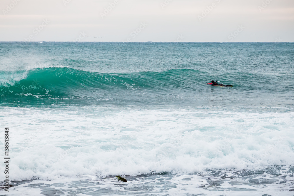 Surfer and wave in ocean. Lifestyle. Surfing in pacific ocean Surfer and wave in ocean. Lifestyle. Surfing in pacific ocean