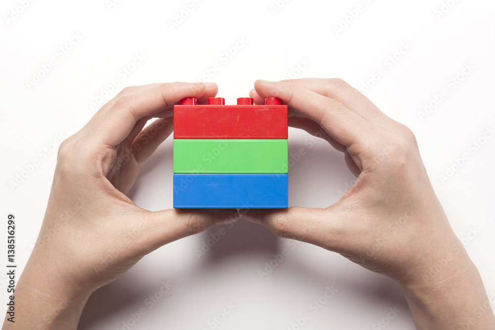 woman hand hold color block(red, green, blue) isolated white woman hand hold color block(red, green, blue) isolated white
