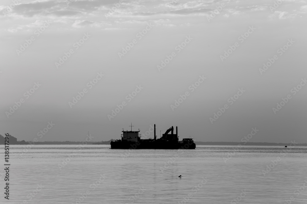 Cargo ship in the sea at dawn Cargo ship in the sea at dawn