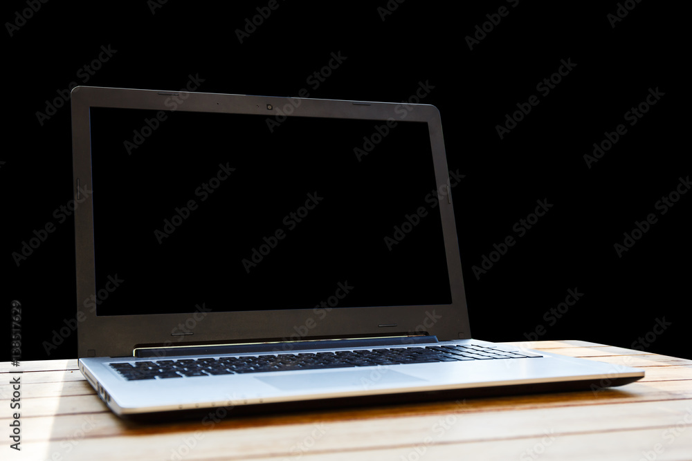Fototapeta premium Computer on a desk on a black background.